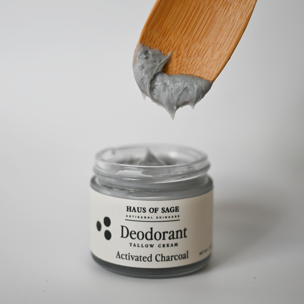 Jar of Haus of Sage deodorant with a wooden applicator on a light gray background