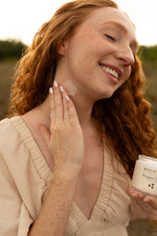 Woman applying whipped tallow to her neck.