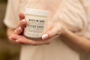 Hands holding  jar of 'Haus of Sage Everything Daily Tallow Creme' .