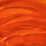 Close-up of orange antioxidant creme 