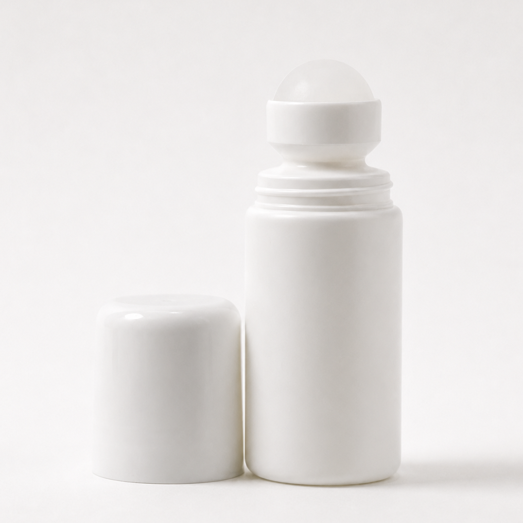 A white roll-on bottle with its matching white cap removed and standing beside it, photographed on a clean white background.