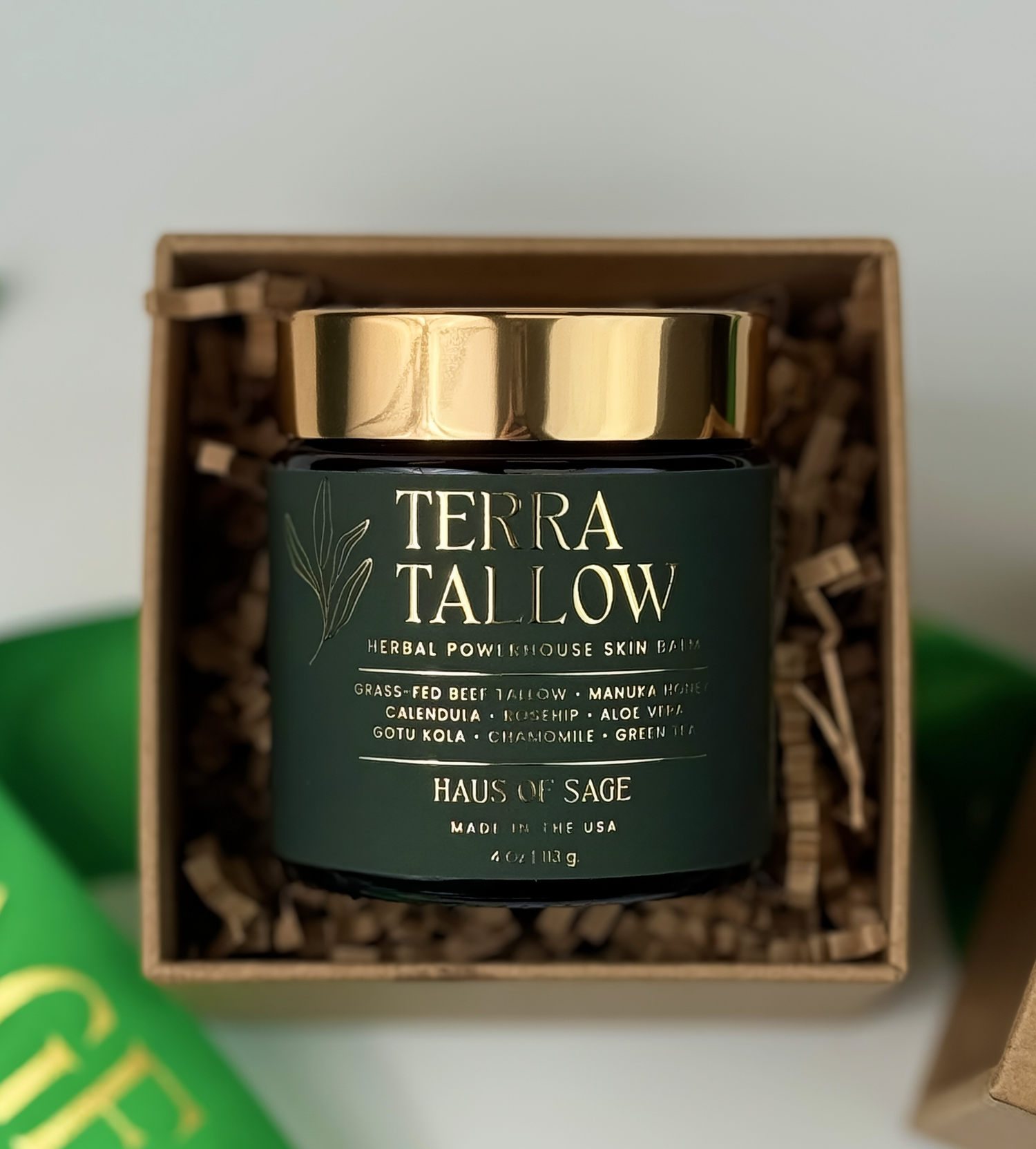 Terra Tallow jar with gold lid in a box on a white background